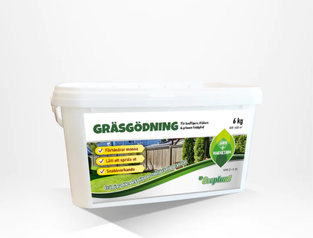 Gräsgödning i en vit hink med järn och magnesium, för en grön och frisk gräsmatta.